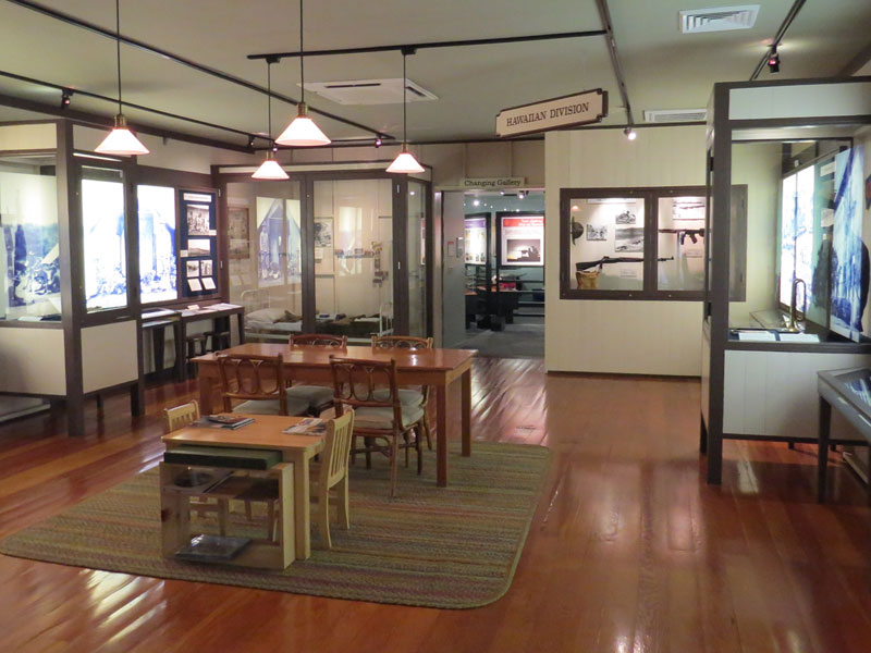 Museum room with several exhibits and wood floors.